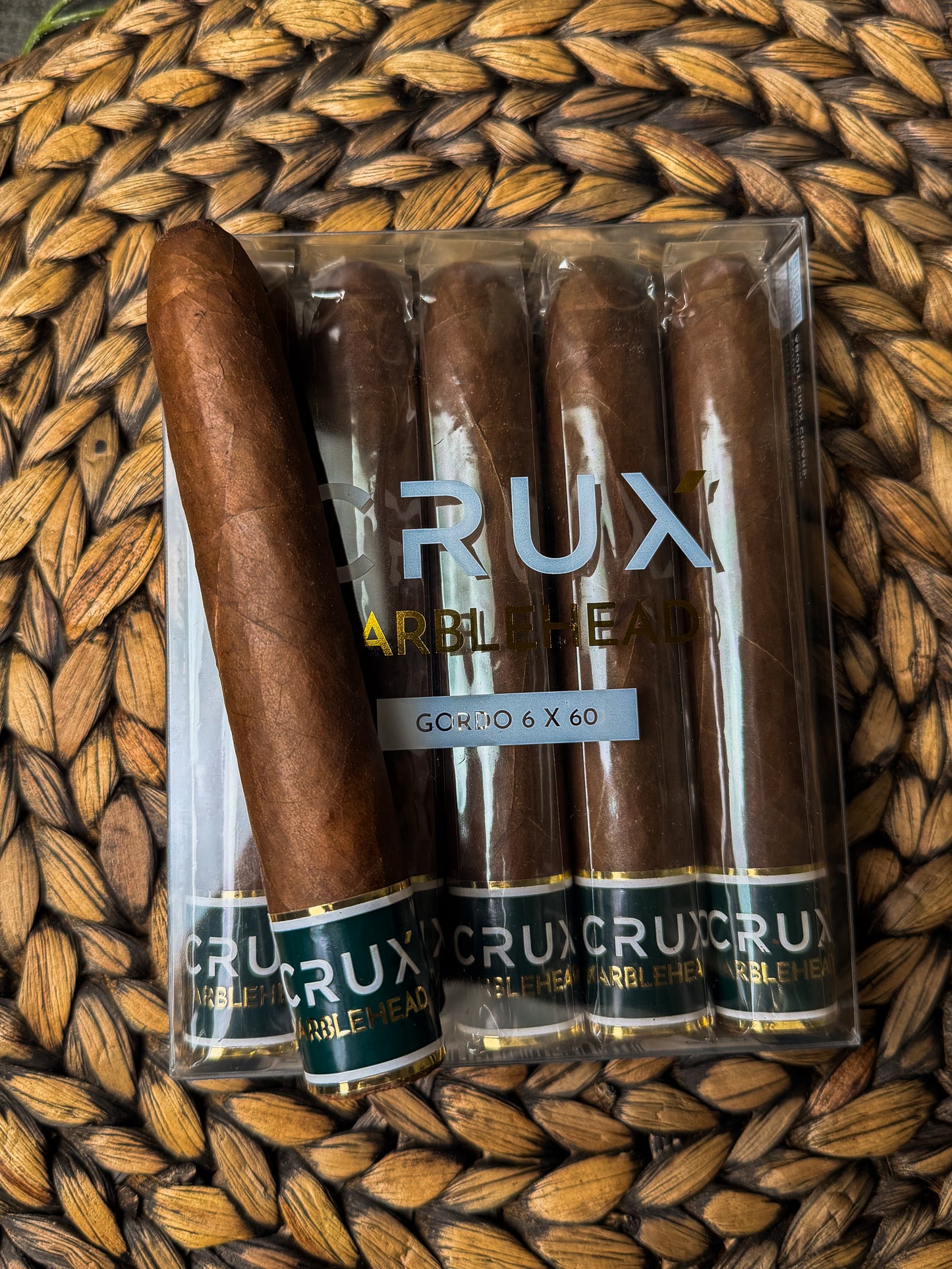 Pack of CRux cigars on a woven mat