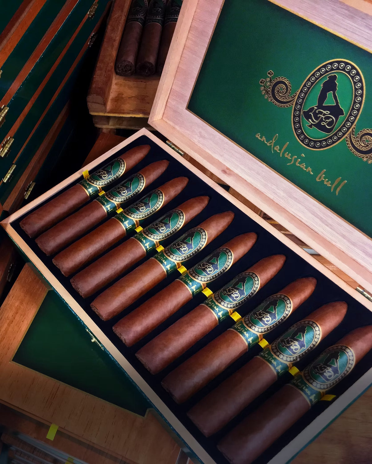 Open wooden box containing cigars with a visible brand logo on a wooden surface.