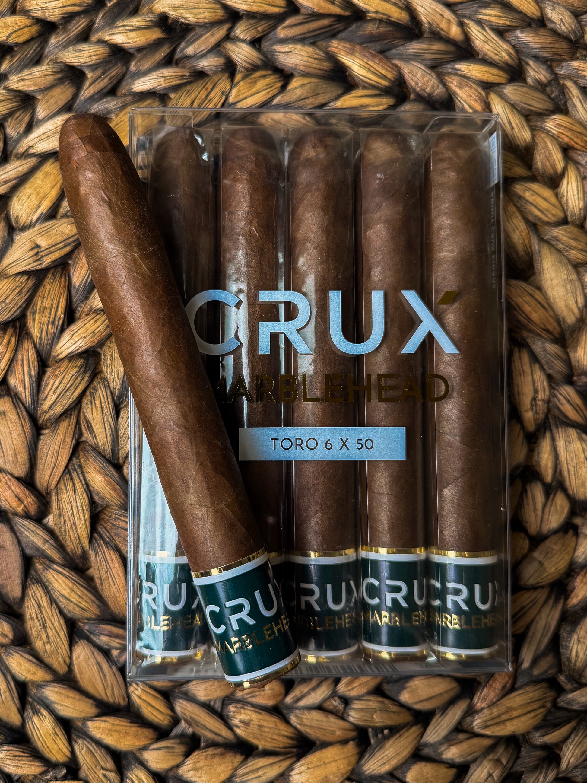 Pack of CRUX cigars on a woven surface
