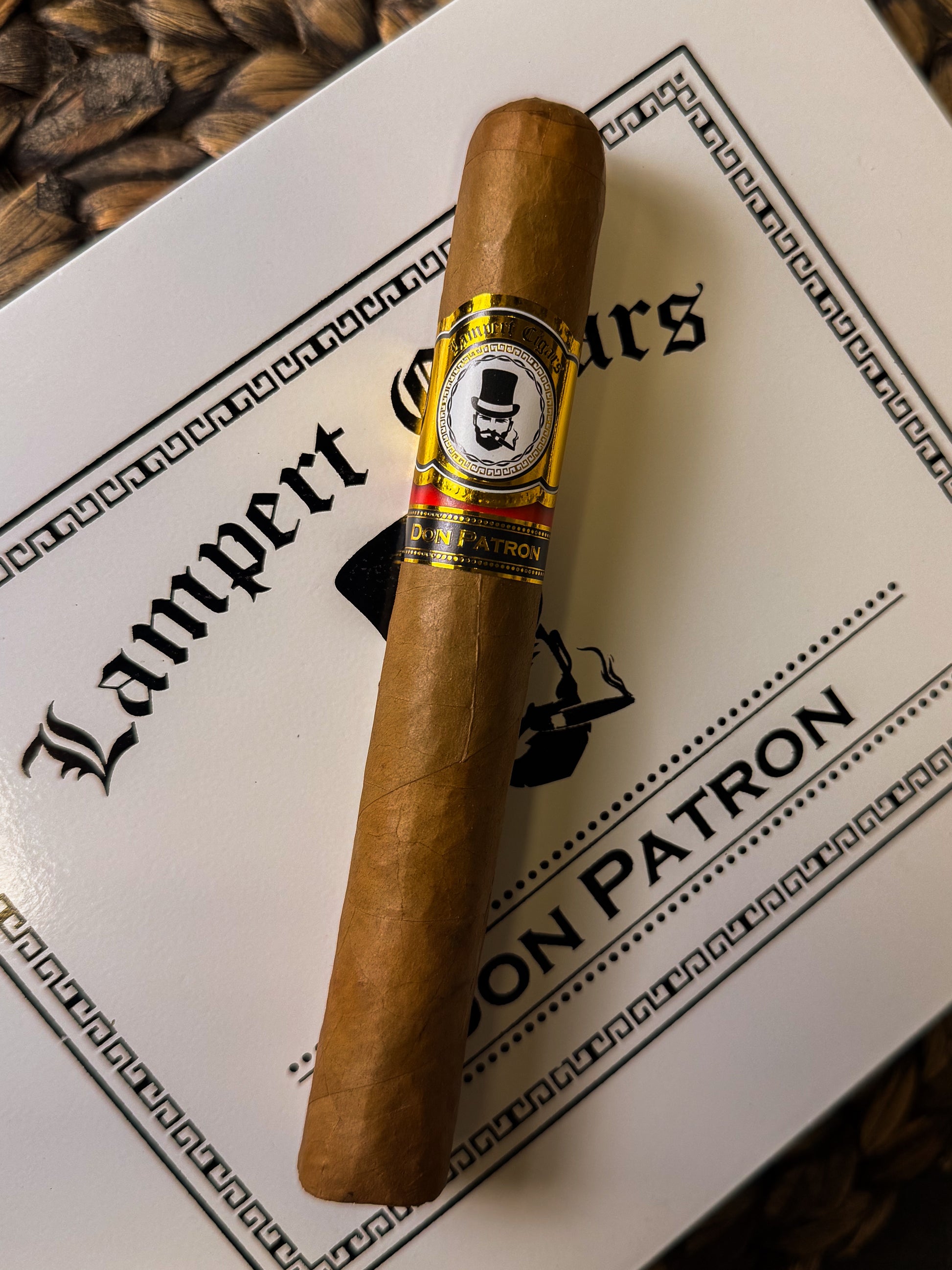 Cigar with a label on a box of Patron cigars