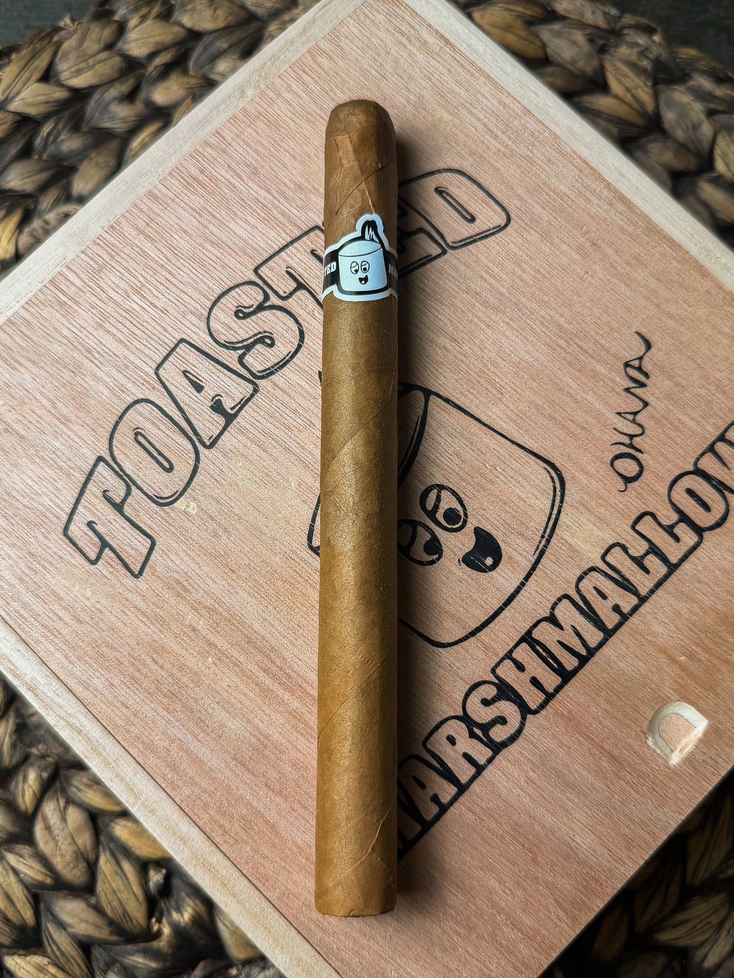 Cigar on a wooden block with 'Toasted Marshmallow' branding