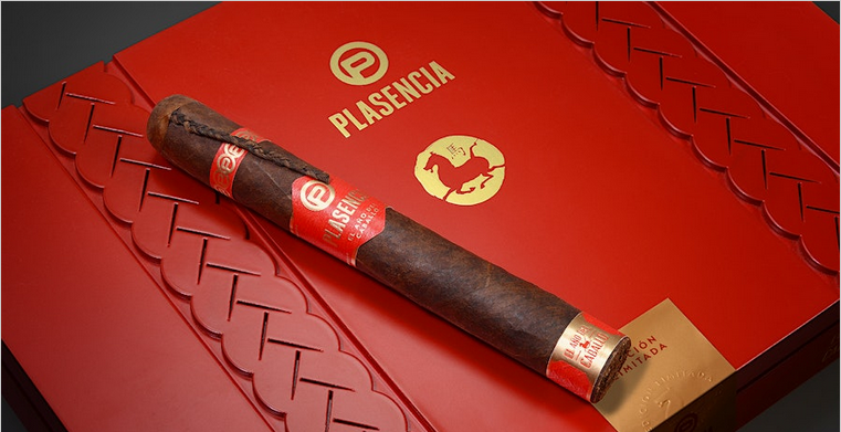 Cigar with a red band on a red Piasencia branded box