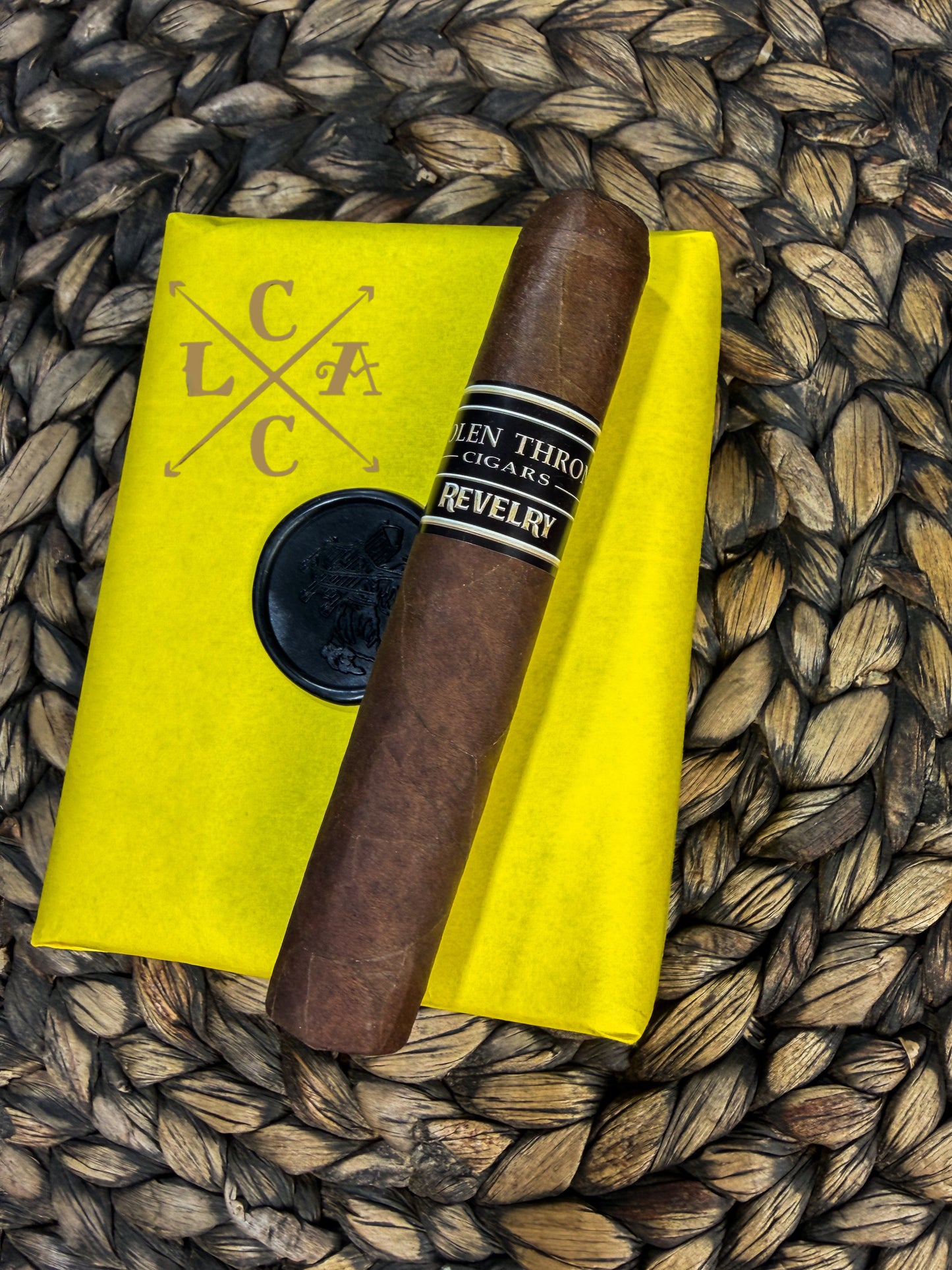 Cigar on a yellow linen with 'LCAC' branding on a woven surface