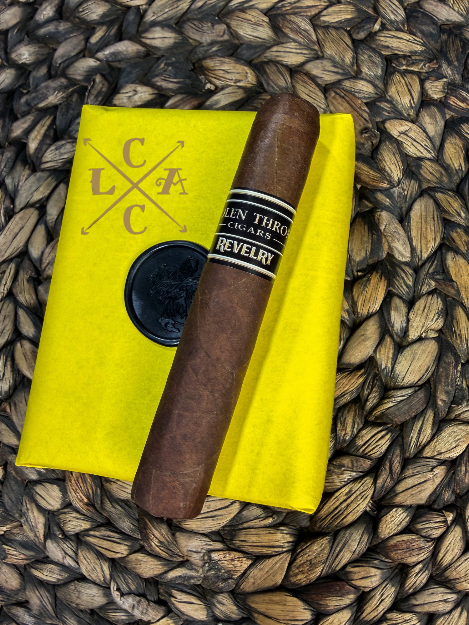 Cigar on a yellow linen with 'LCAC' branding on a woven surface