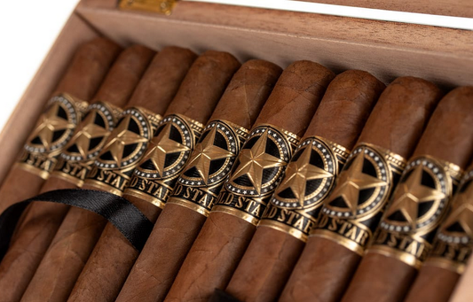 Close-up of cigars with decorative bands in a wooden box