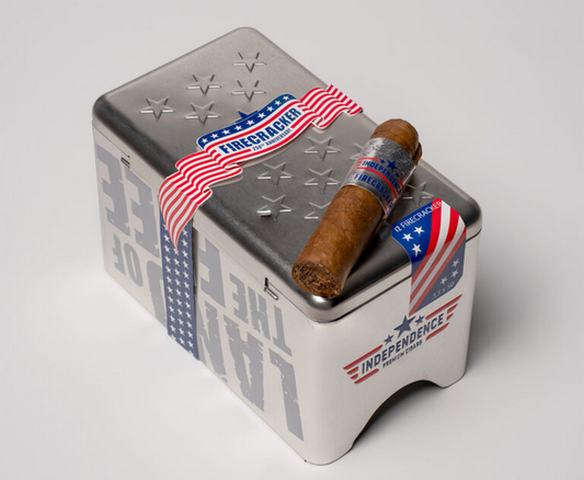 Cigar with a patriotic wrapper on a metal container featuring American flag designs.